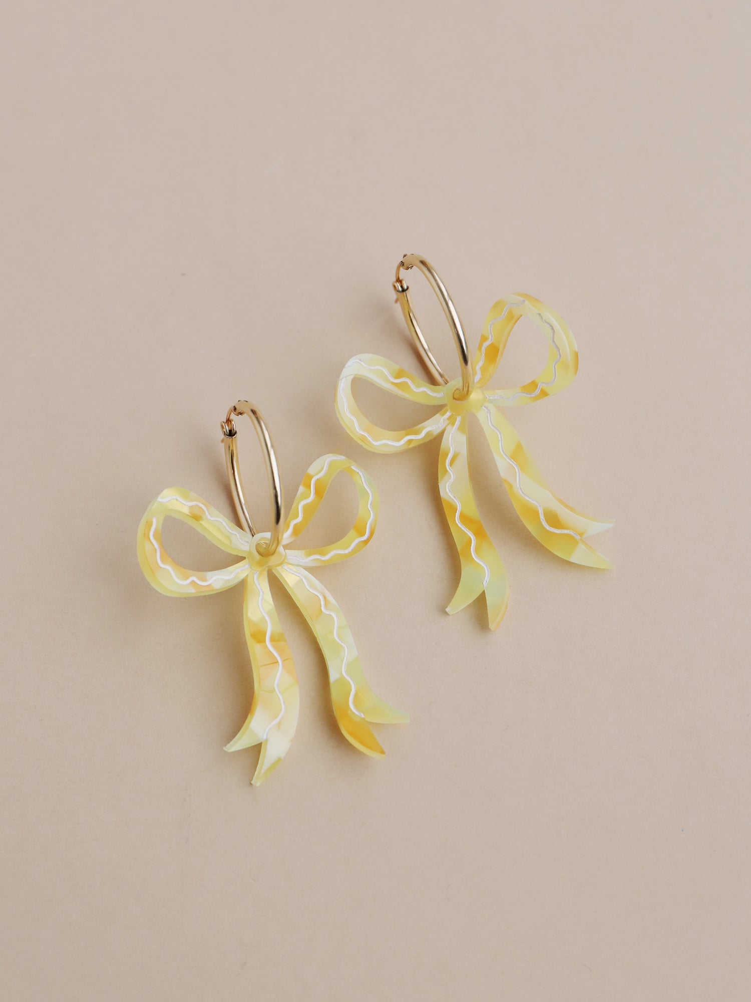 Gingham bow hoop earrings. Made from acrylic with hand-inked details and 14k gold-filled hoops. Handmade in the UK by Wolf & Moon.