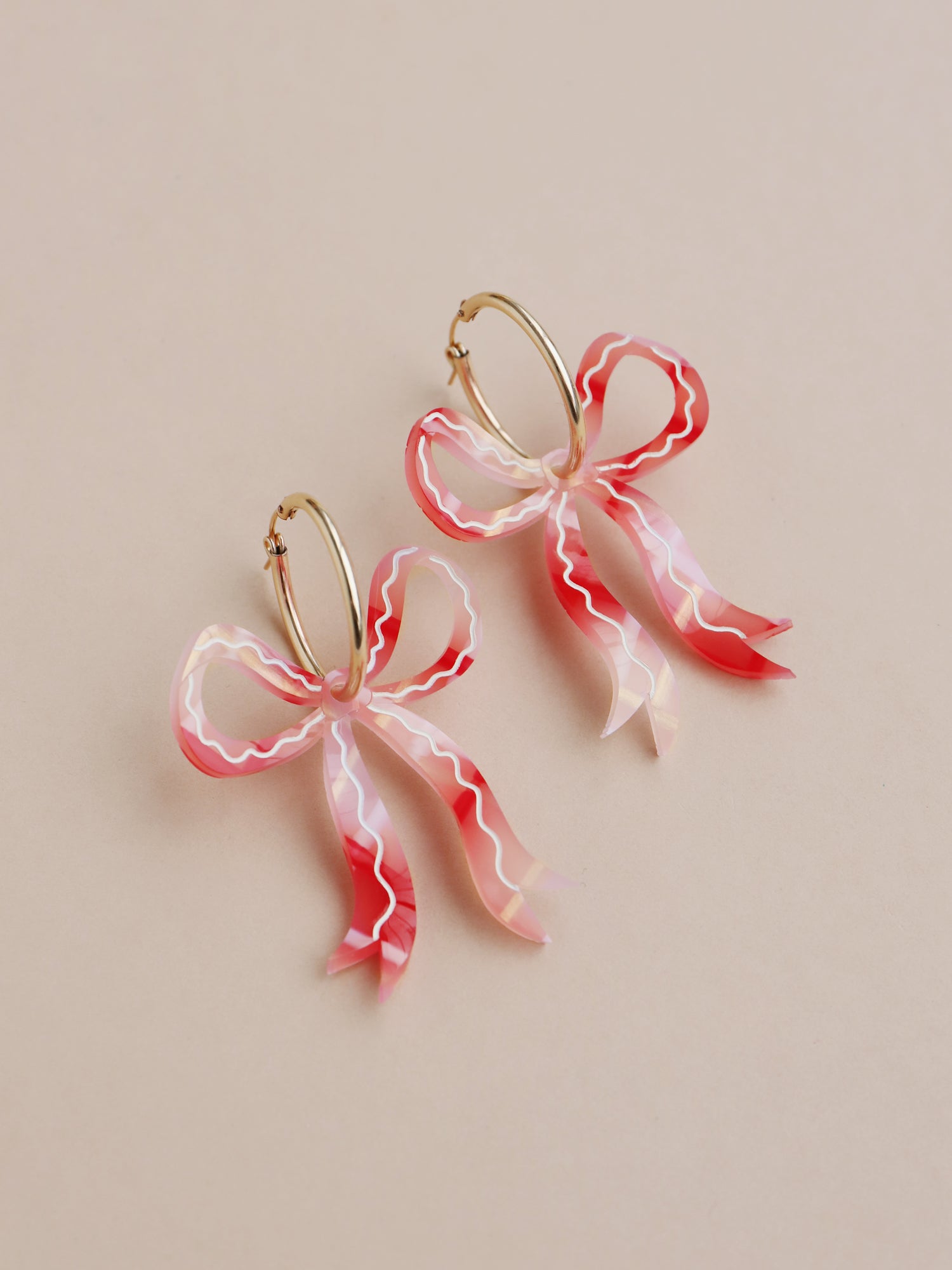 Gingham bow hoop earrings. Made from acrylic with hand-inked details and 14k gold-filled hoops. Handmade in the UK by Wolf & Moon.