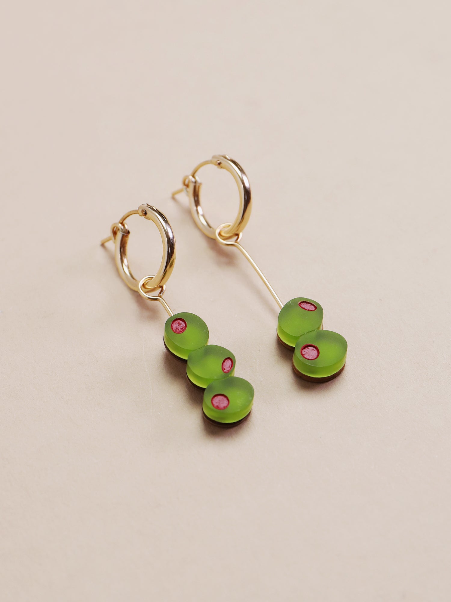 Green & red cocktail olive hoop earrings. Made from acrylic with 14k gold-filled findings & hoops. Handmade in the UK by Wolf & Moon.