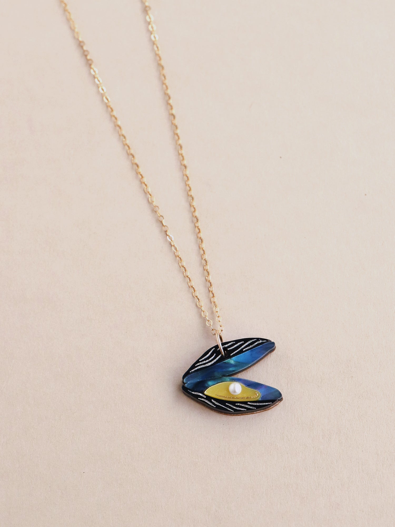 Blue mussel necklace. Made from acrylic with glass pearls and 14k gold-filled findings & chain. Handmade in the UK by Wolf & Moon.