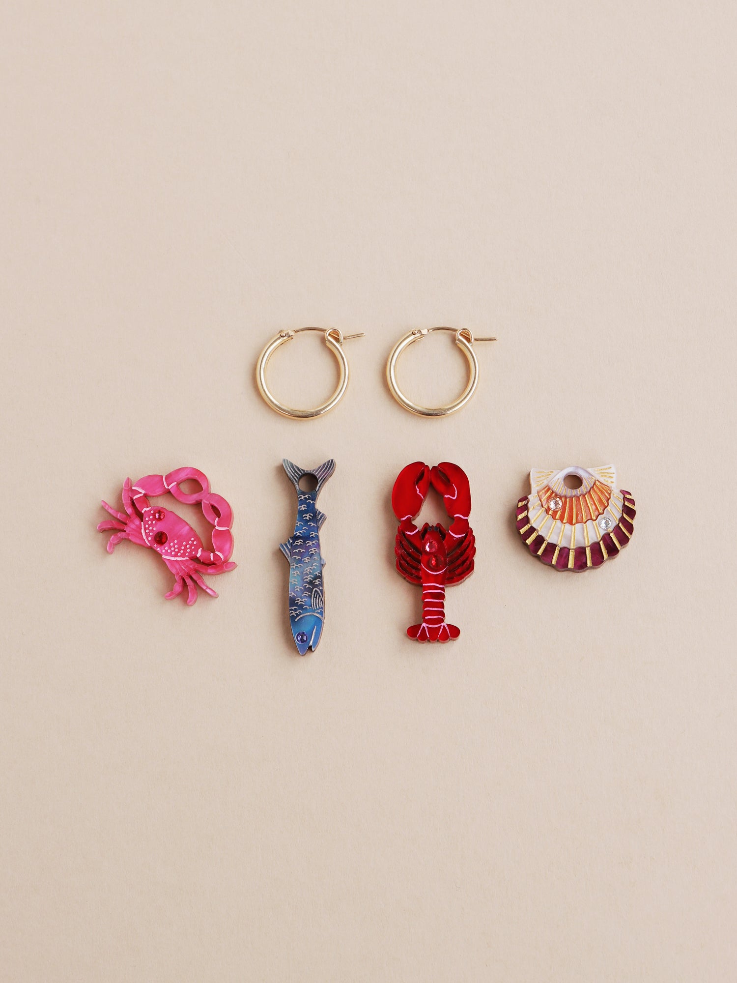 Ocean hoop earrings set with 4 interchangeable mix and match charms. Made from acrylic with high quality glass crystals and 14k gold-filled findings & hoops. Handmade in the UK by Wolf & Moon.