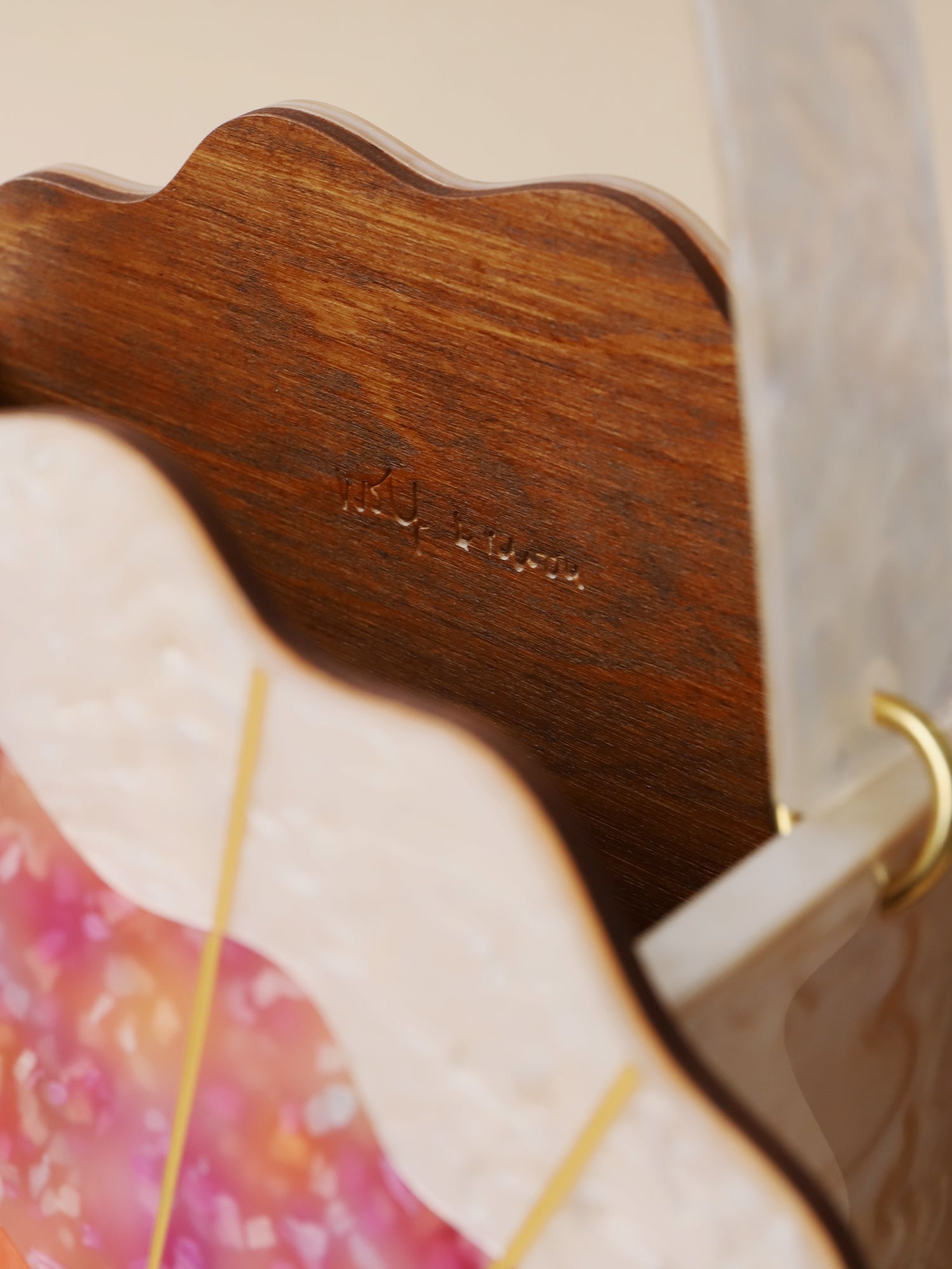 Orange, cream & pink iridescent acrylic shallop shell bag. Made with an acrylic exterior, FSC-approved wood interior and solid brass findings. Handmade in the UK by Wolf & Moon.
