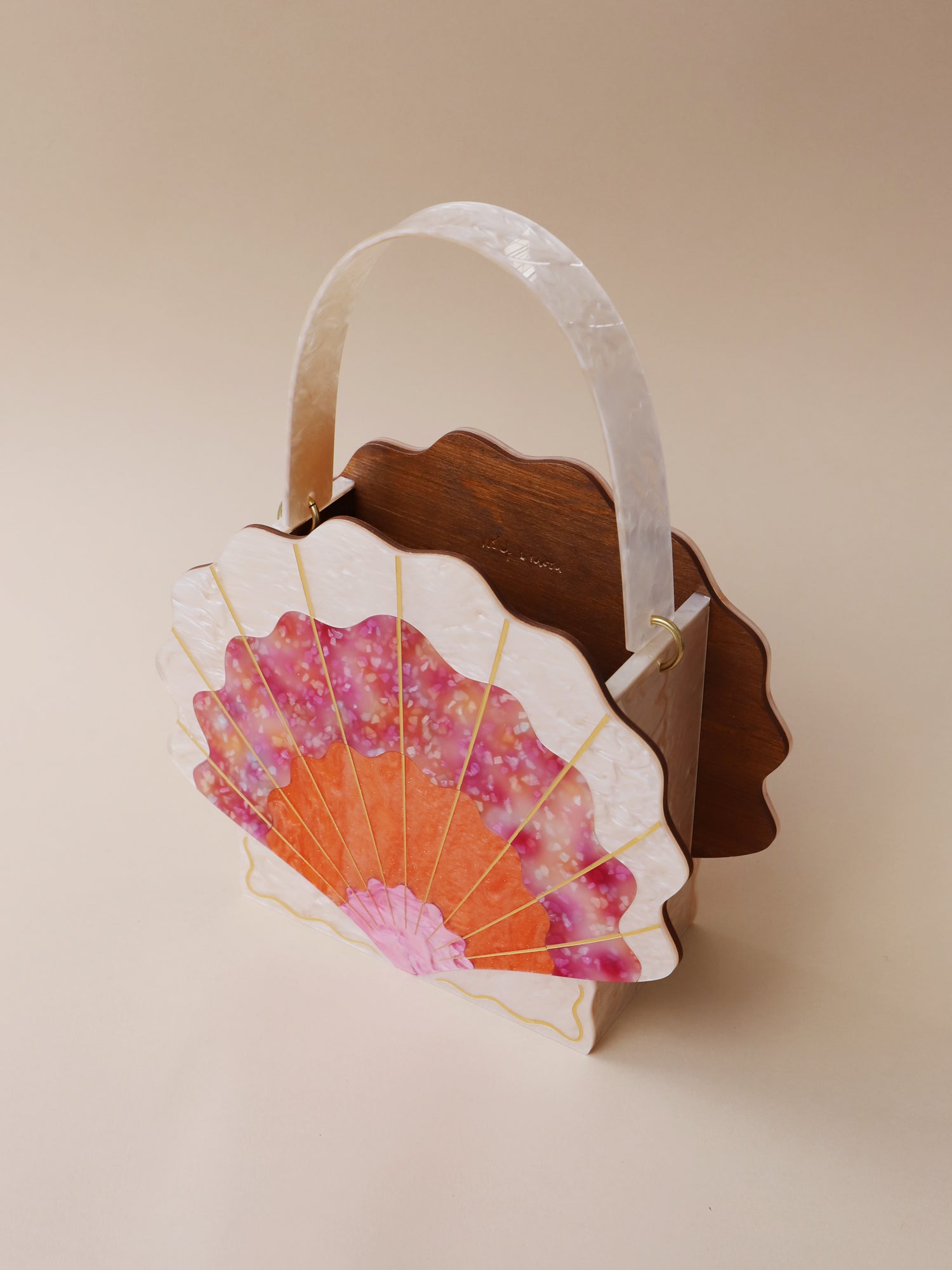 Orange, cream & pink iridescent acrylic shallop shell bag. Made with an acrylic exterior, FSC-approved wood interior and solid brass findings. Handmade in the UK by Wolf & Moon.