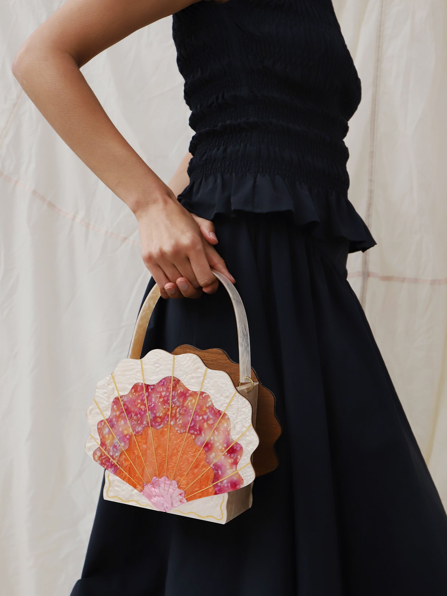 Orange, cream & pink iridescent acrylic shallop shell bag. Made with an acrylic exterior, FSC-approved wood interior and solid brass findings. Handmade in the UK by Wolf & Moon.