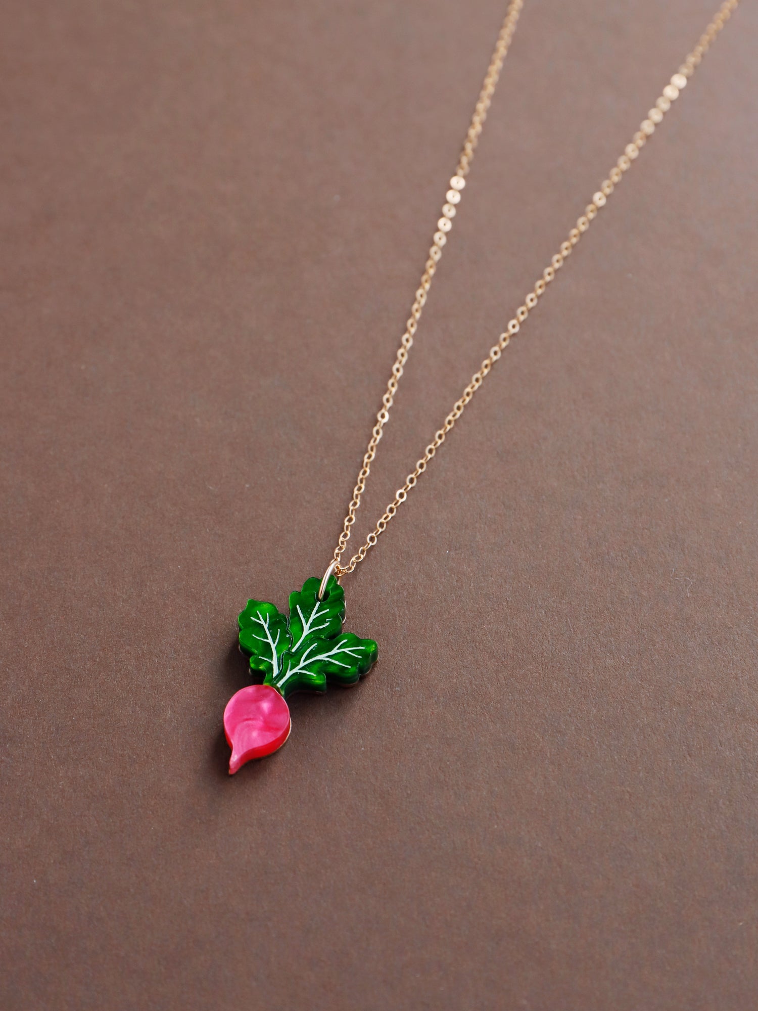 Pink and green mini acrylic radish pendant necklace with optional gold-filled chain. Handmade in London by Wolf & Moon.