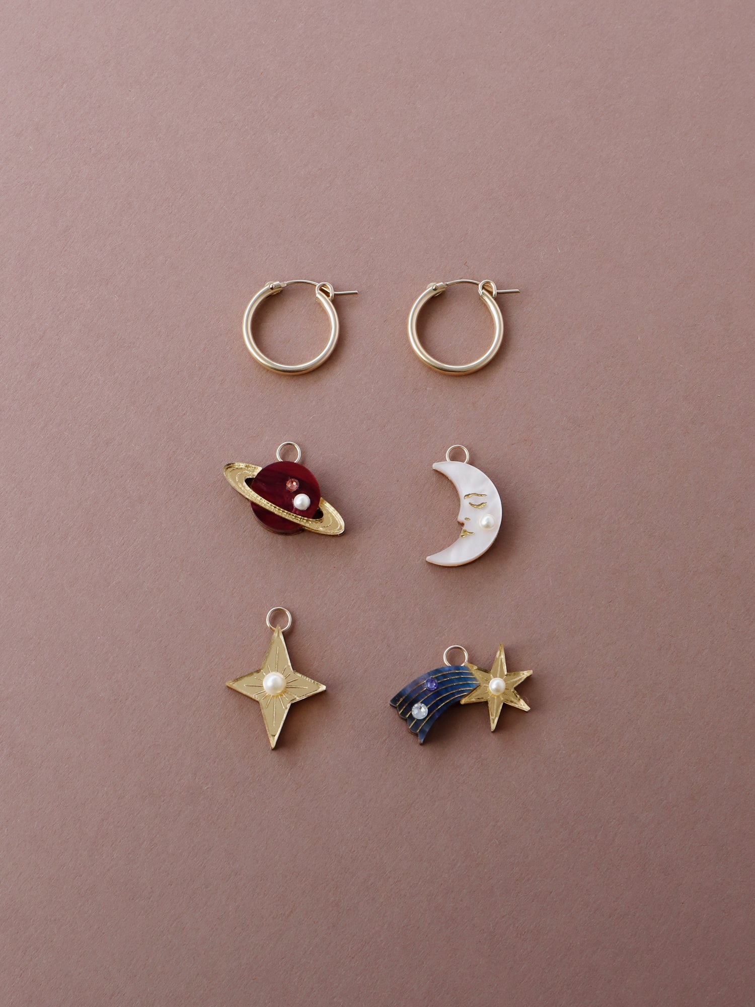 Mix ‘n’ match celestial charm set made with acrylic and glass pearls. This hoop set includes 4 x interchangeable charms. Wear with our 14k gold-filled hoops. This set includes: 1x 'Moon' charm, 1x ‘Star’ charm , 1 x 'Shooting Star' charm, 1 x 'Saturn' charm. Handmade in London by Wolf & Moon.